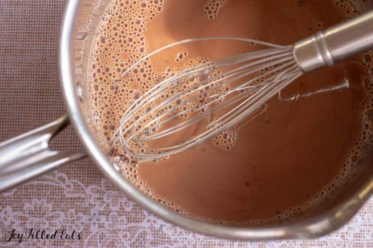 saucepan of hot chocolate with whisk