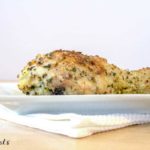 Parmesan crusted baked chicken leg on white plate