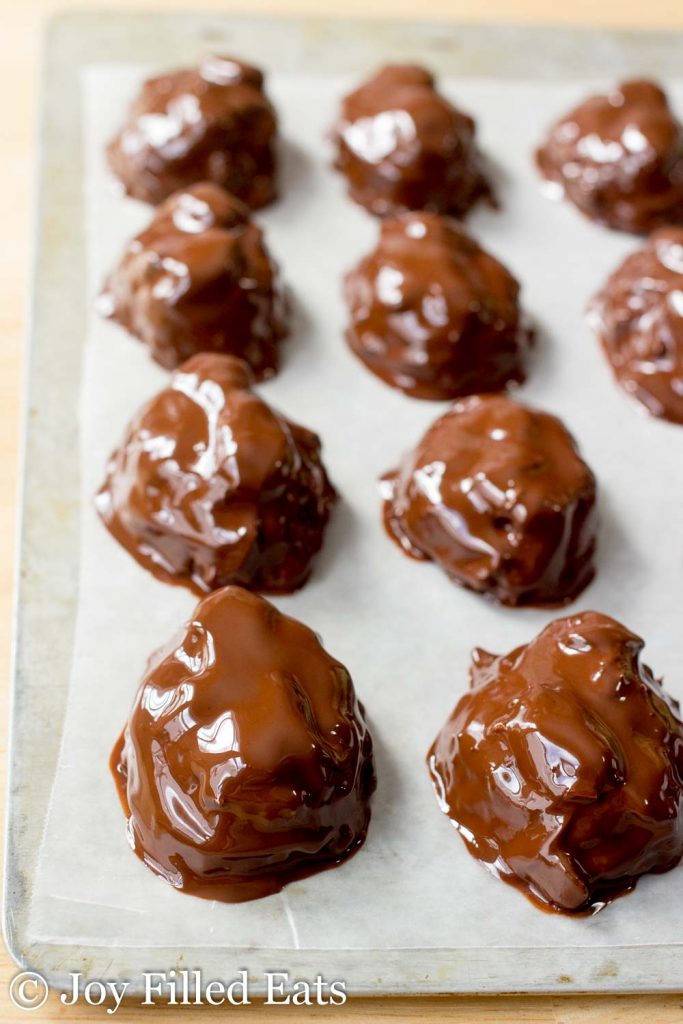 homemade almond joy candies lined on parchment paper coated in chocolate