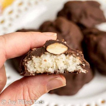 hand holding homemade almond joy candy cut in half