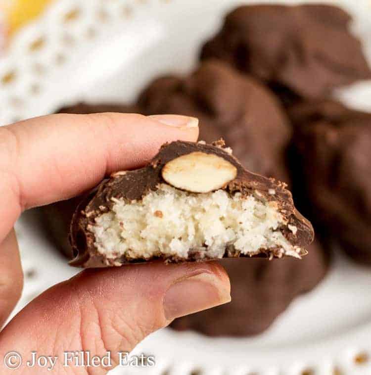 hand holding homemade almond joy candy cut in half