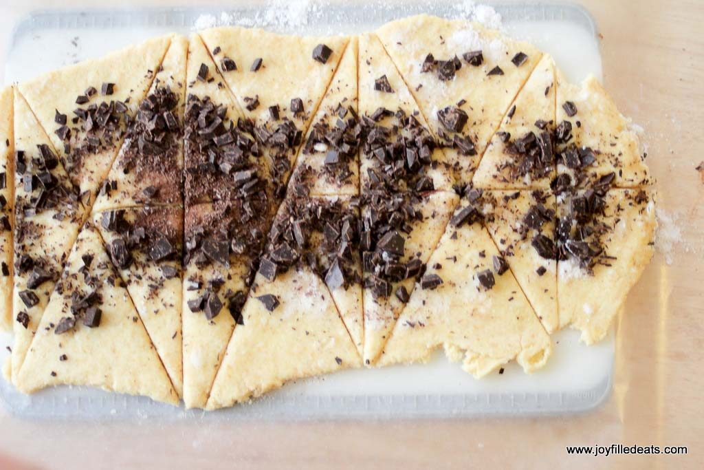 crescent cookie dough rolled out and pre-cut topped with chocolate shavings and chips