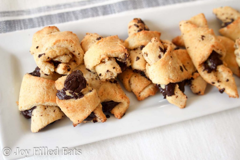 white platter full of dark chocolate crescent cookies
