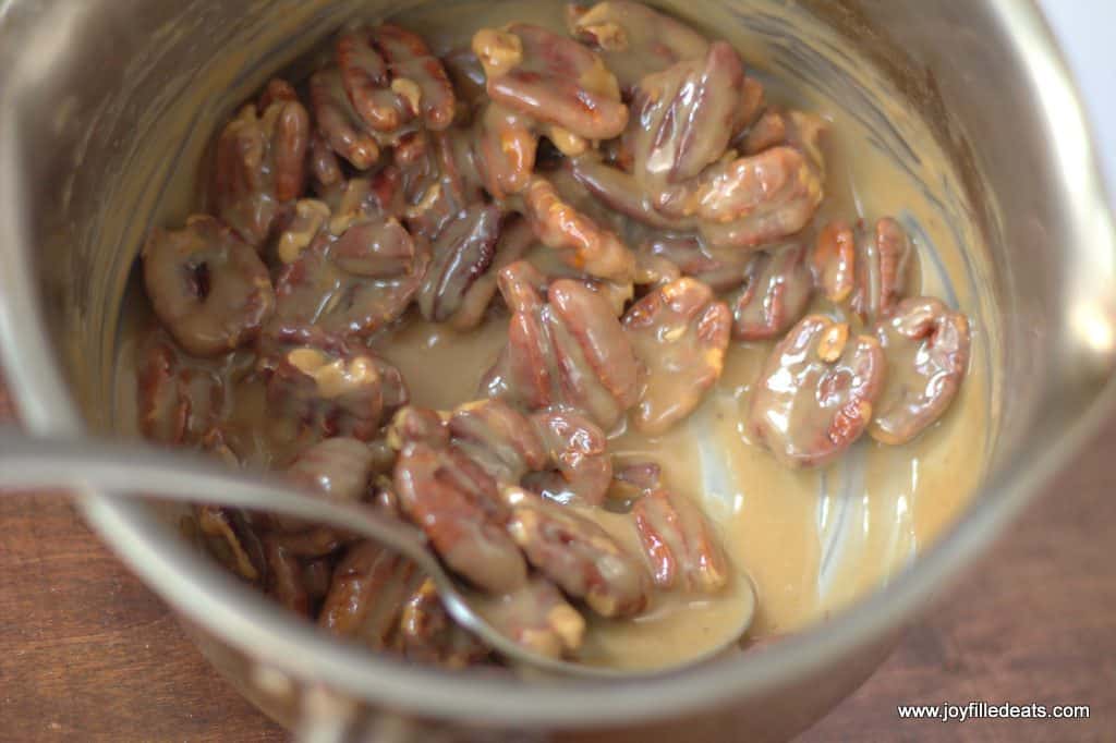 overhead view of keto pecan praline batter in a mixing bowl with spoon