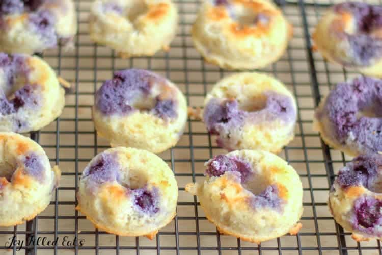 keto lemon blueberry donuts on a cooling rack up close