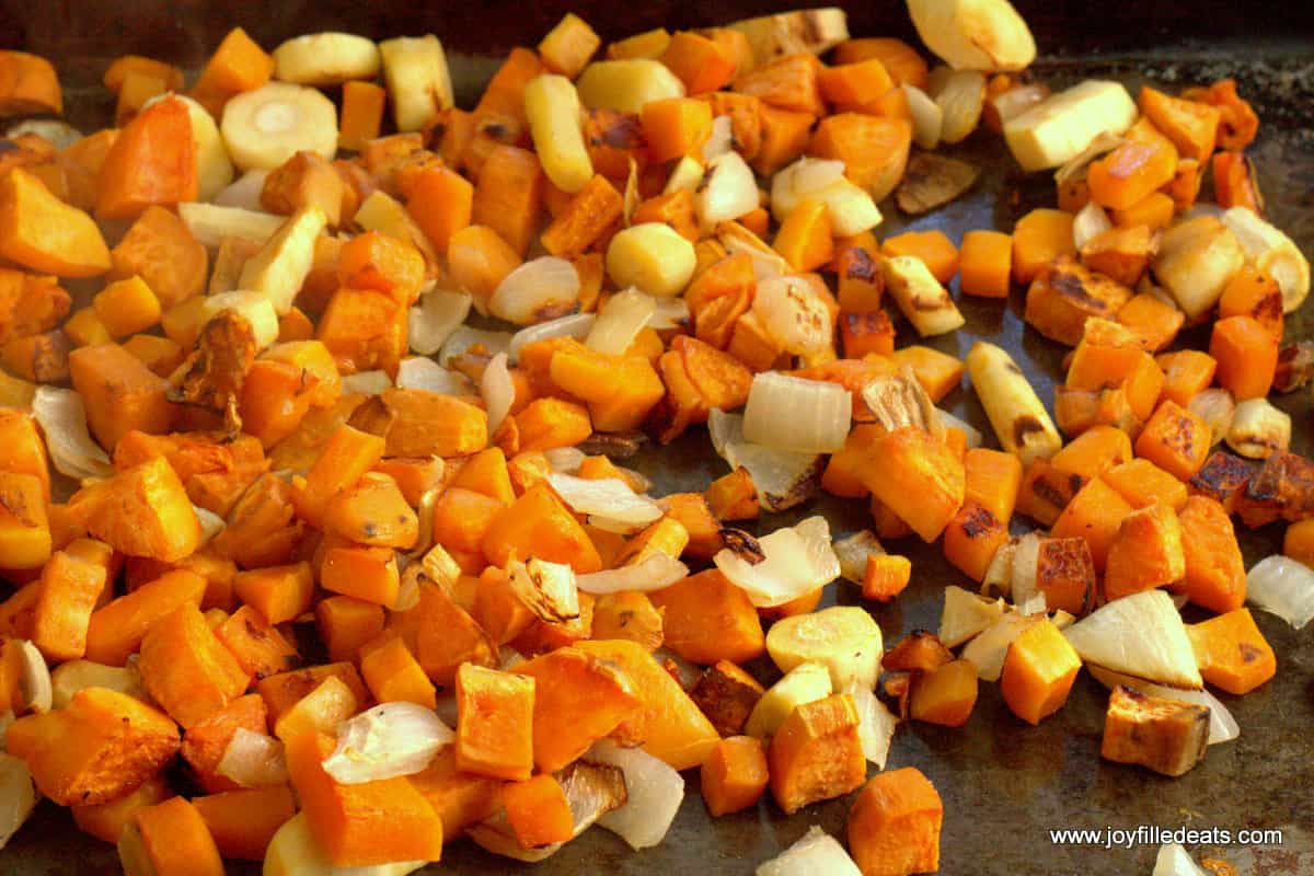 diced roasted root vegetables close up on a sheet pan