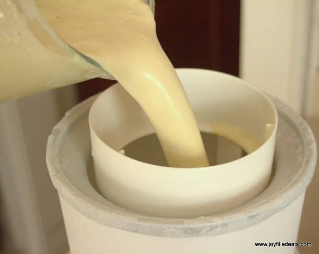 sugar free pistachio ice cream mixture being poured into an ice cream maker