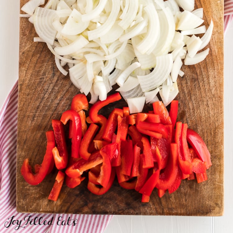 cut peppers and onions on cutting board