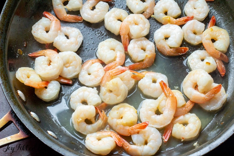 shrimp sauteing in a skillet up close