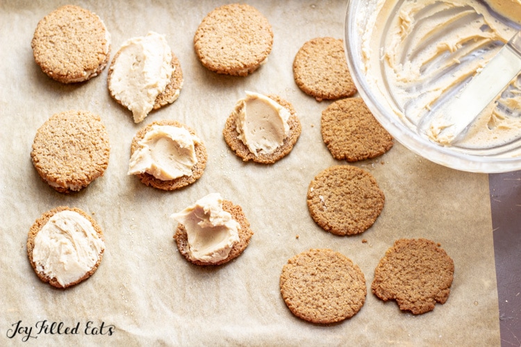 maple icing being spread on cookies