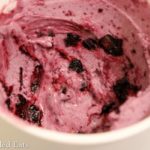 container of blueberry ripple cheesecake ice cream close up