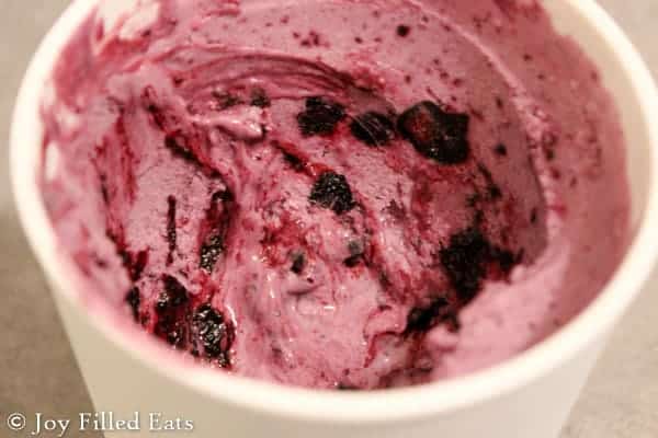 container of blueberry ripple cheesecake ice cream close up