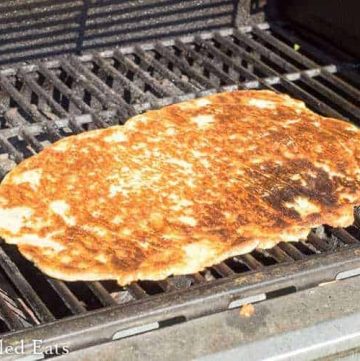 fathead low carb pizza dough placed on a grill rack