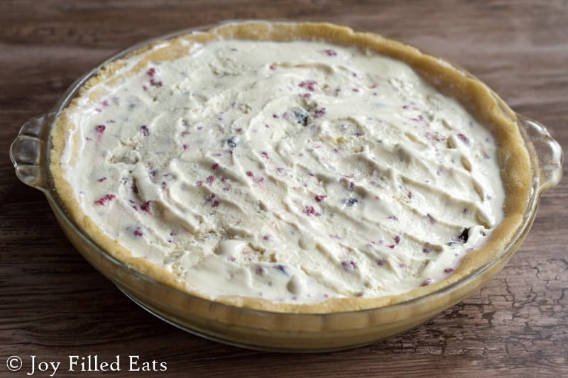 berry and cream filling placed in a pie plate with crust for low carb berries & cream ice cream pie