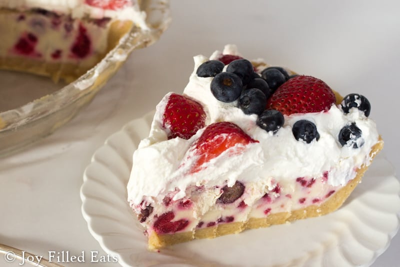 slice of low carb berries and cream ice cream pie on a white plate