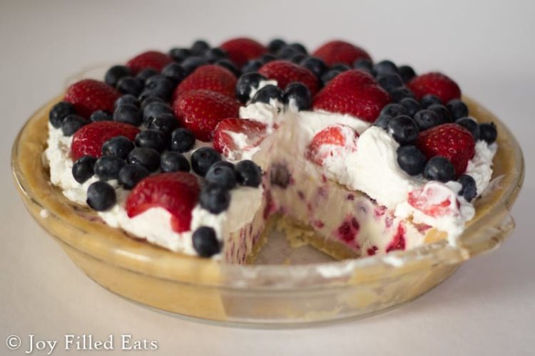 glass pie plate with low carb berries & cream ice cream pie with slice missing