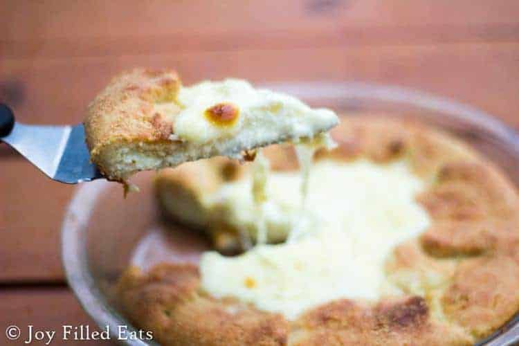 serving spatula lifting slice of keto cheese calzone pie from pie plate