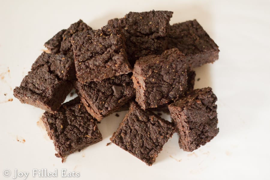 pile of keto fudge brownies set on a white surface