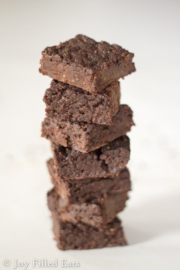 large stack of keto fudge brownies on a white surface