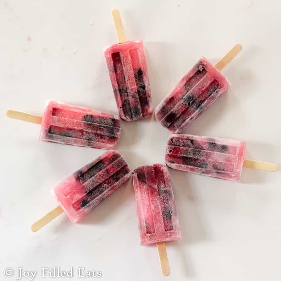 sugar free Berrylicious ice pops arranged in a circle on a white surface from above