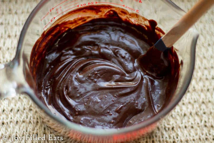 large mixing bowl of melted dark chocolate close up