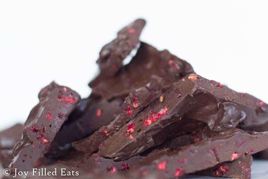 close up on pile of dark chocolate raspberry truffle bark