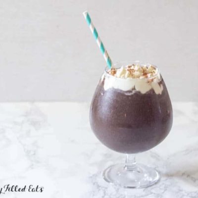 frozen hot chocolate topped with whipped cream and a paper straw