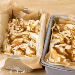 two parchment lined metal containers filled with sweet cream coffee caramel ice cream