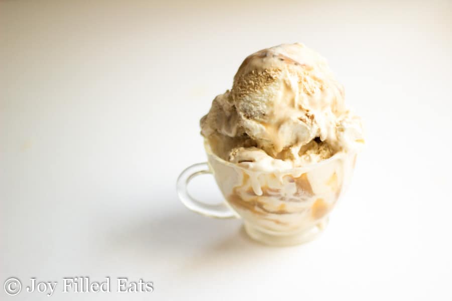 scoop of sweet cream coffee caramel ice cream in a small glass mug