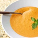 tomato basil soup in bowl with spoon