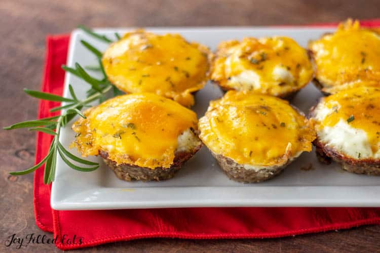 Sausage Egg Muffins on white platter atop a red napkin