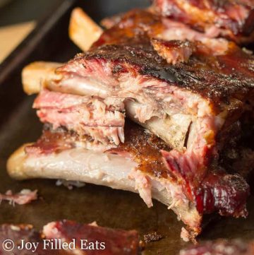 close up on stack of ribs on a sheet pan