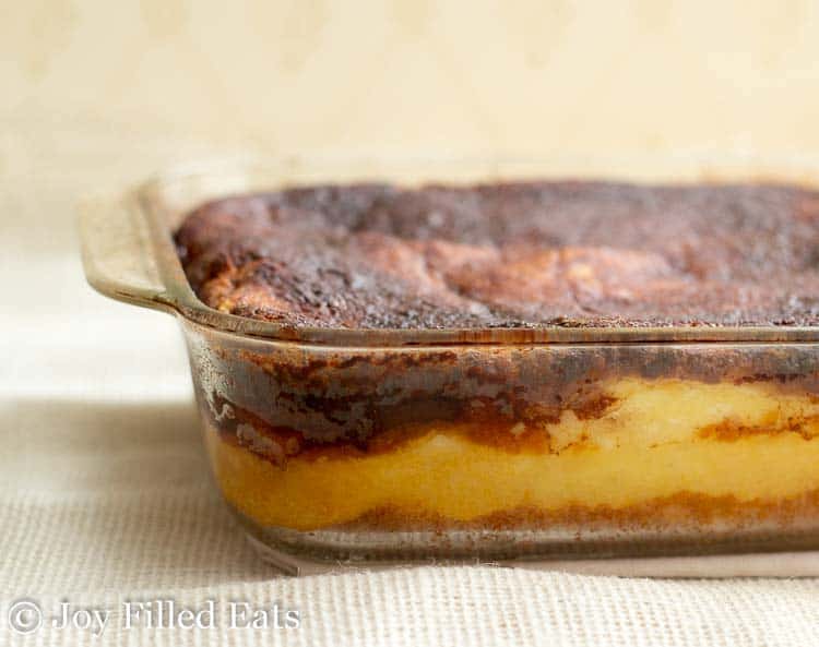sopapilla cheesecake bars in a casserole dish before being cut into squares