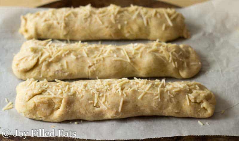 filled dough lined on parchment paper before baking