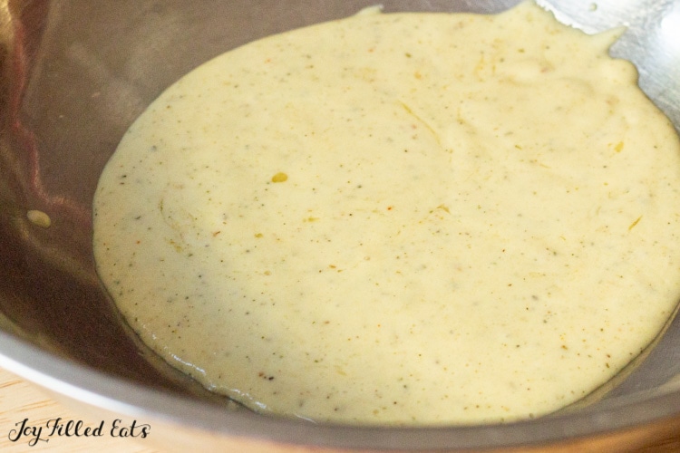 close up on garlic parmesan sauce in a large mixing bowl