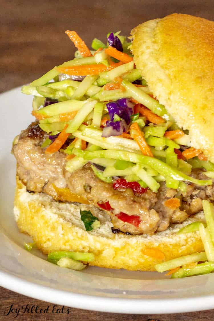 close up of asian burger with broccoli slaw