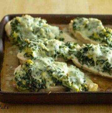 sheet pan lined with spinach artichoke chicken breasts