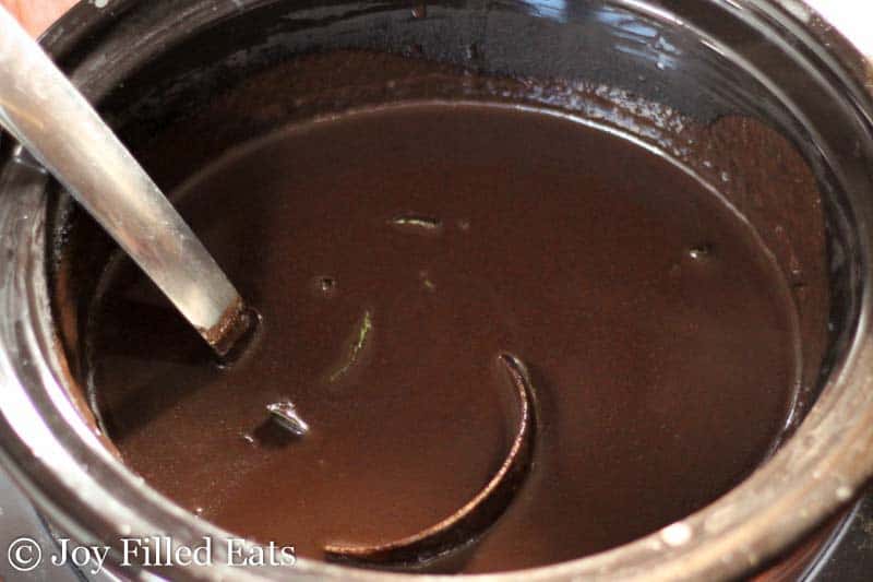 crock pot full of peppermint hot chocolate with a ladle