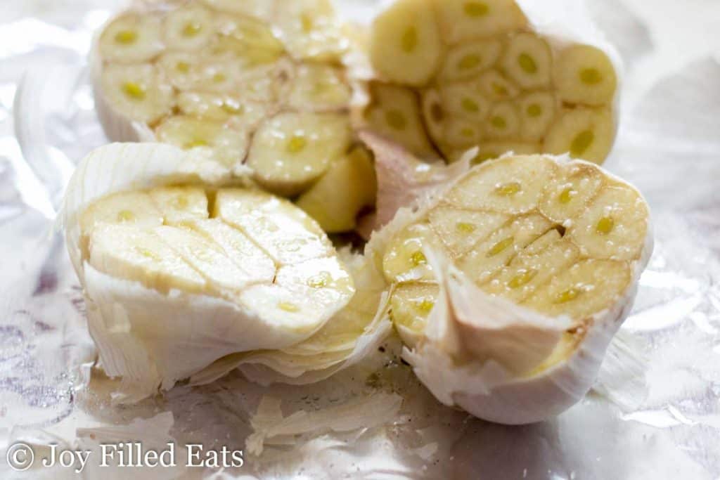 close up on two garlic bulbs sliced in half