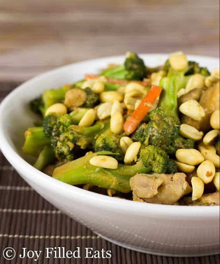 close up on bowl of thai peanut chicken and broccoli