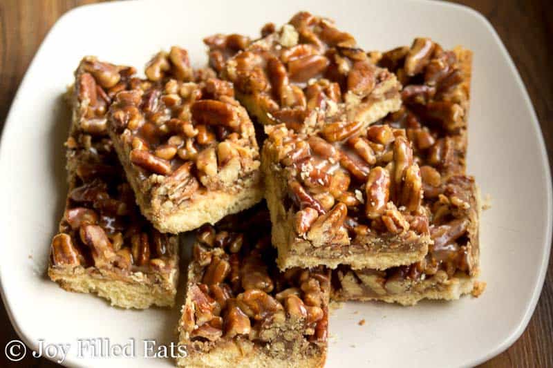 pile of pecan praline cookie bars on a white plate from above