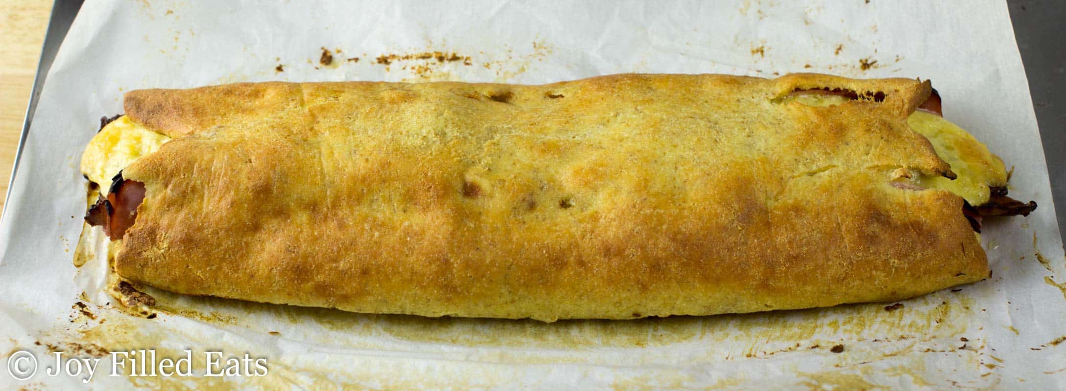 loaded stromboli placed on parchment paper