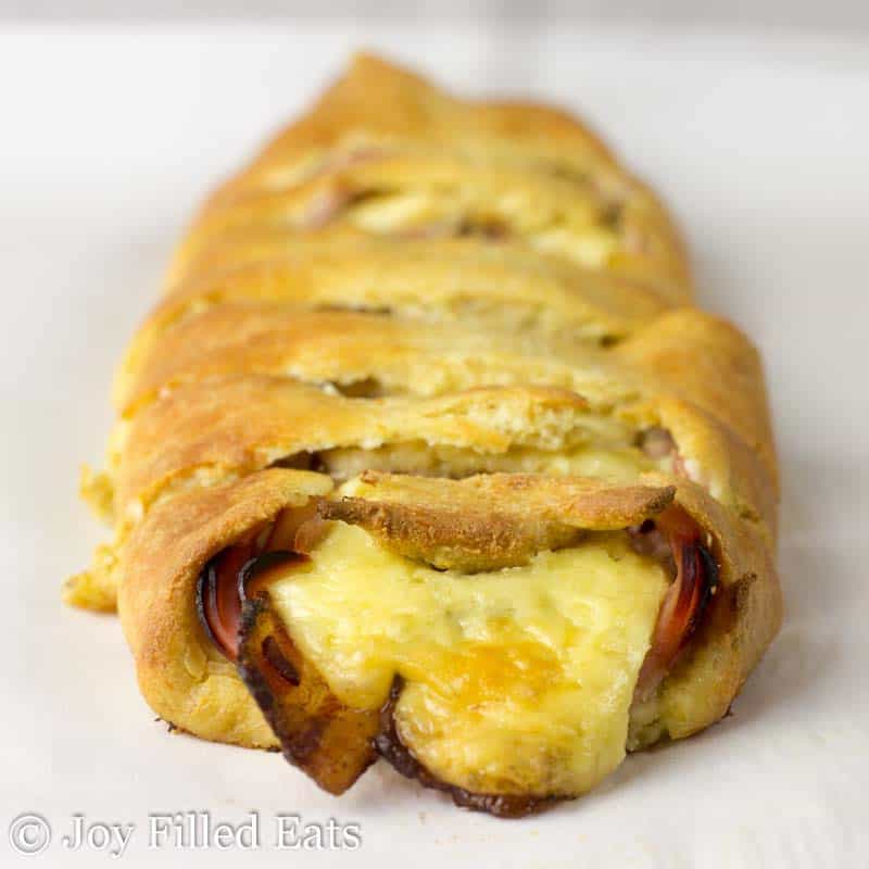 close up on loaded stromboli on a white surface