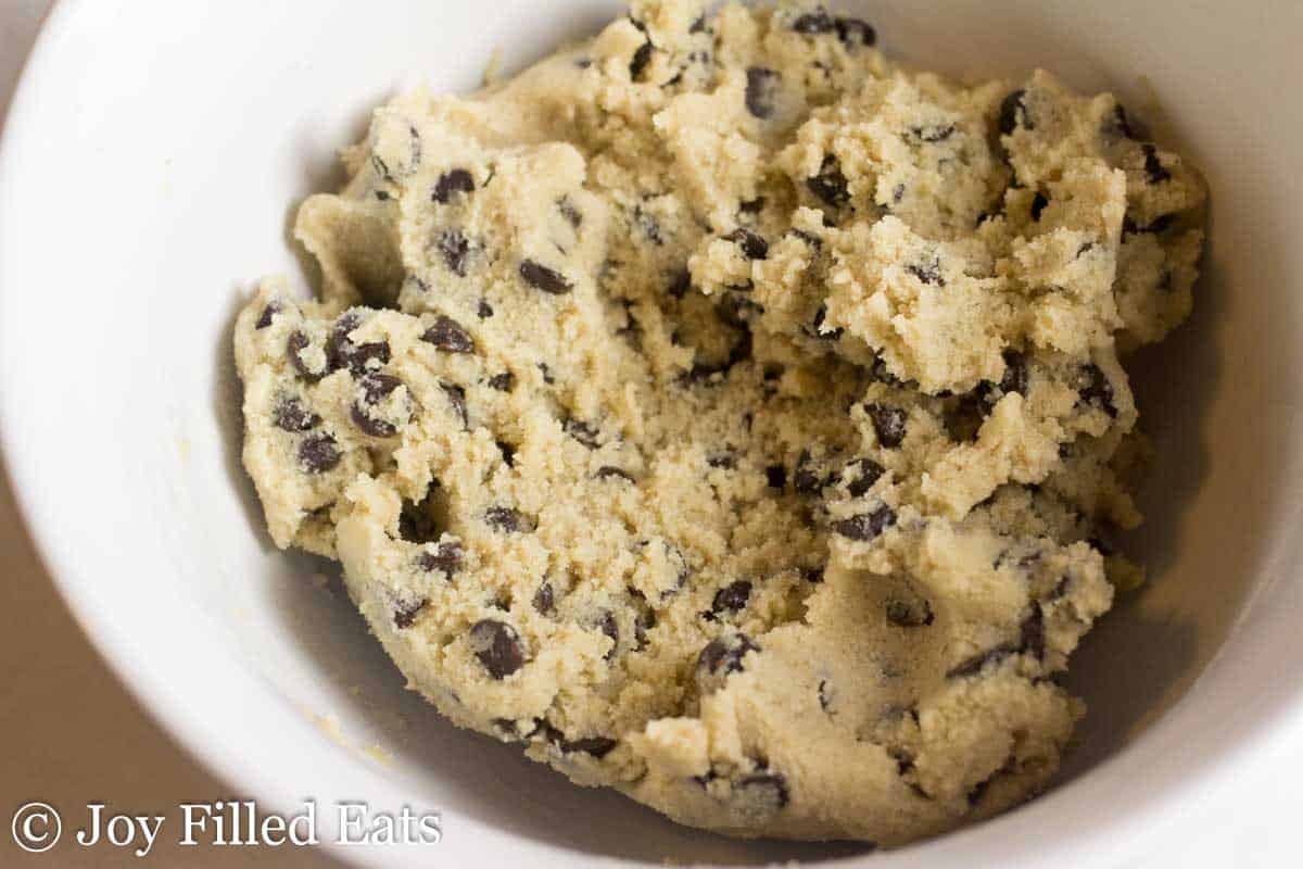 chocolate chip shortbread cookie dough in a white mixing bowl