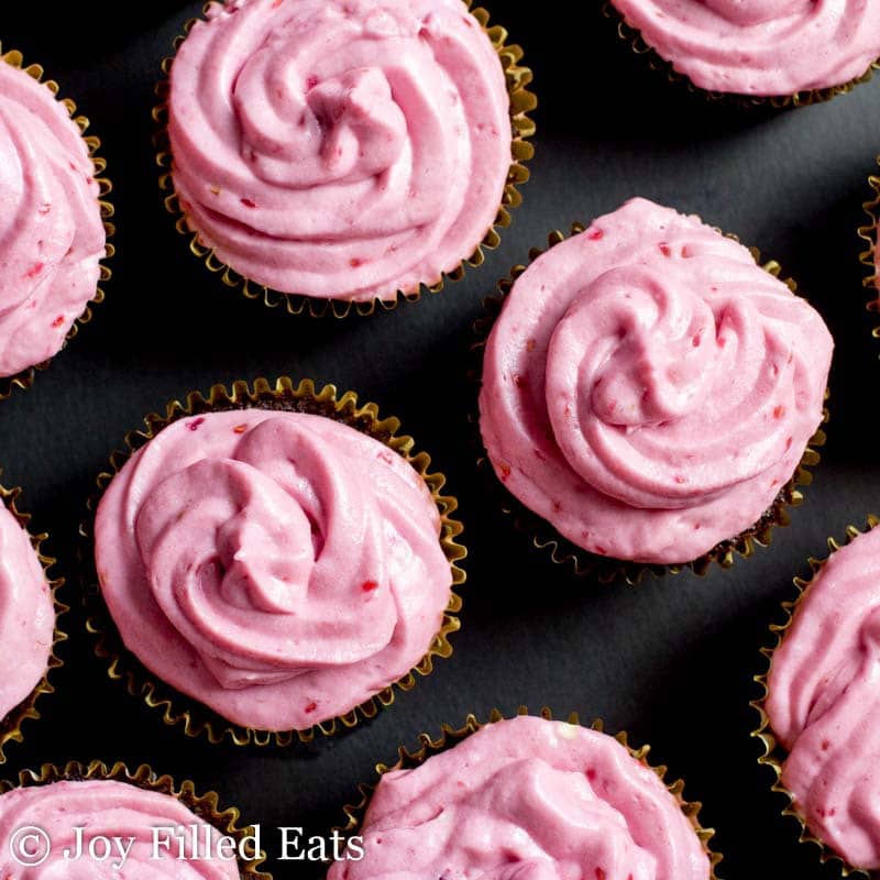 overhead view of chocolate champagne cupcakes with raspberry icing