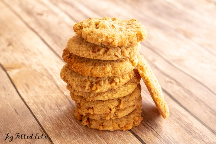 stack of butter pecan cookies with one of it's side on wood table.