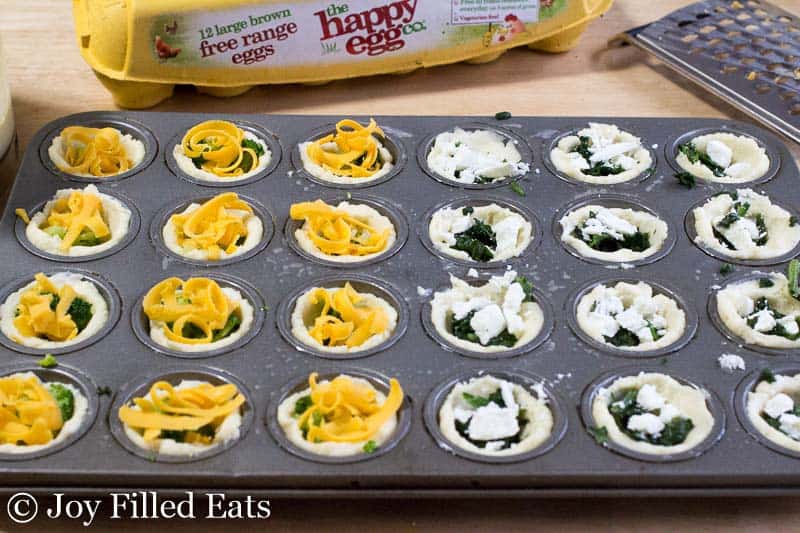 two separate quiche toppings filled into mini muffin tin