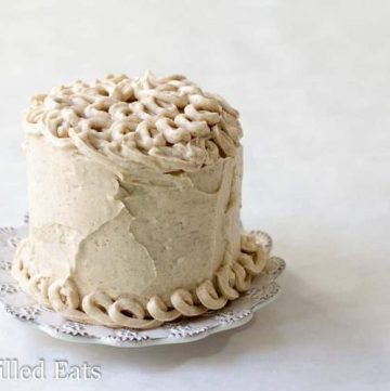 icing decorated mini snickerdoodle layer cake on a white plate