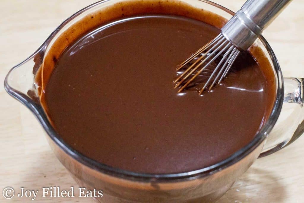 large mixing bowl of chocolate pudding mixture with whisk