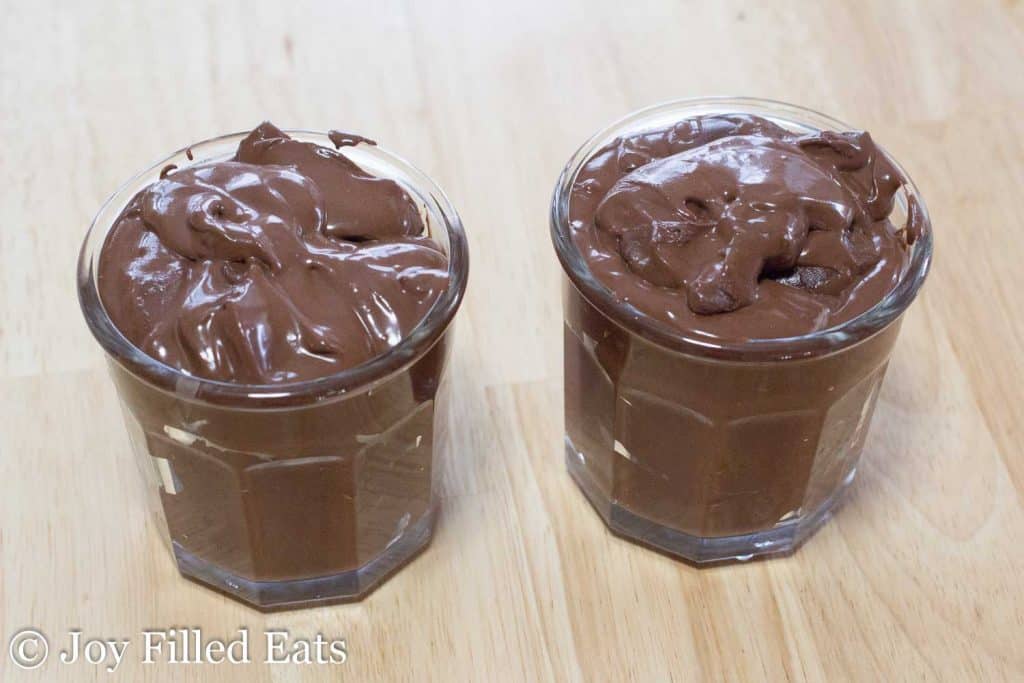 two glasses filled with dairy and sugar free chocolate pudding
